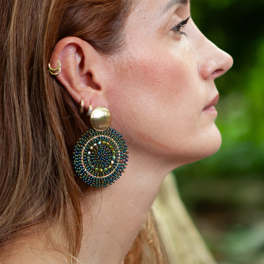 These earrings are handcrafted with colorful beadwork on a delicate wire and feature a bronze stud with a gleaming gold plating, available in a variety of colors.